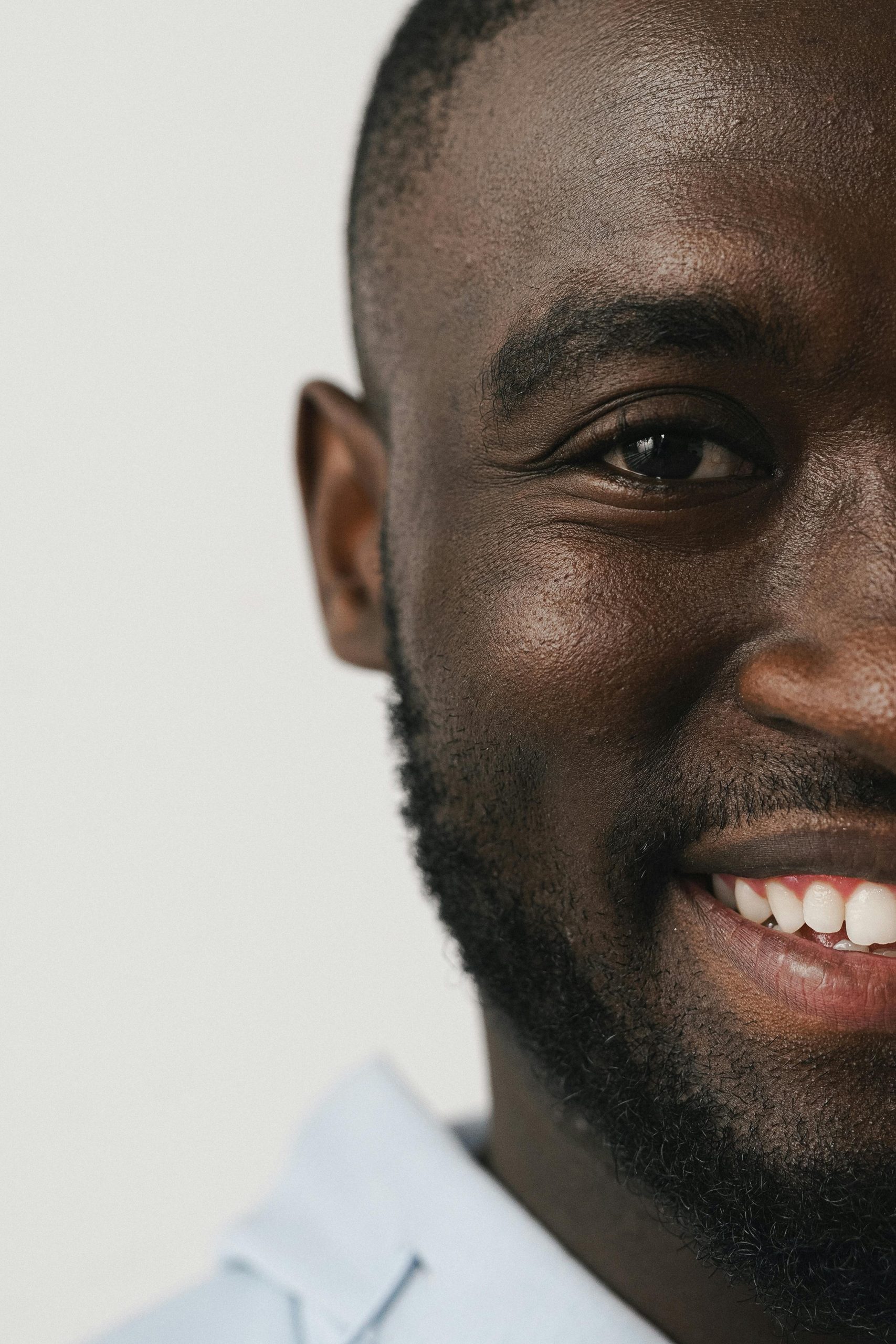 Close-up of a smiling man with a beard showing positive emotion.